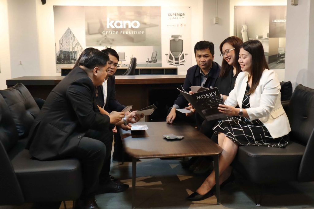 Mustard Seed team in a meeting around a low table.